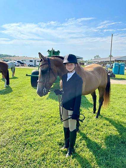 Night Sun Stables rider preparing to show at a horse show