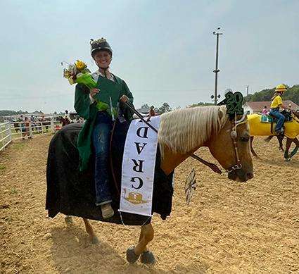 A Night Sun Stables rider celebrating success at a horse show