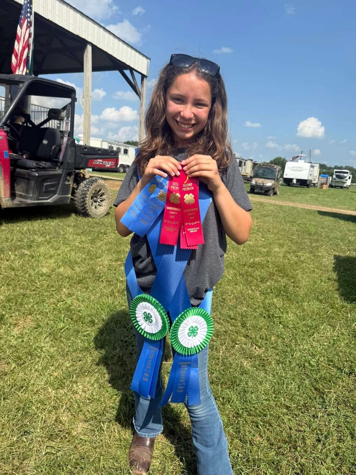 Night Sun Stables 4-H rider with her award ribbons at the fair