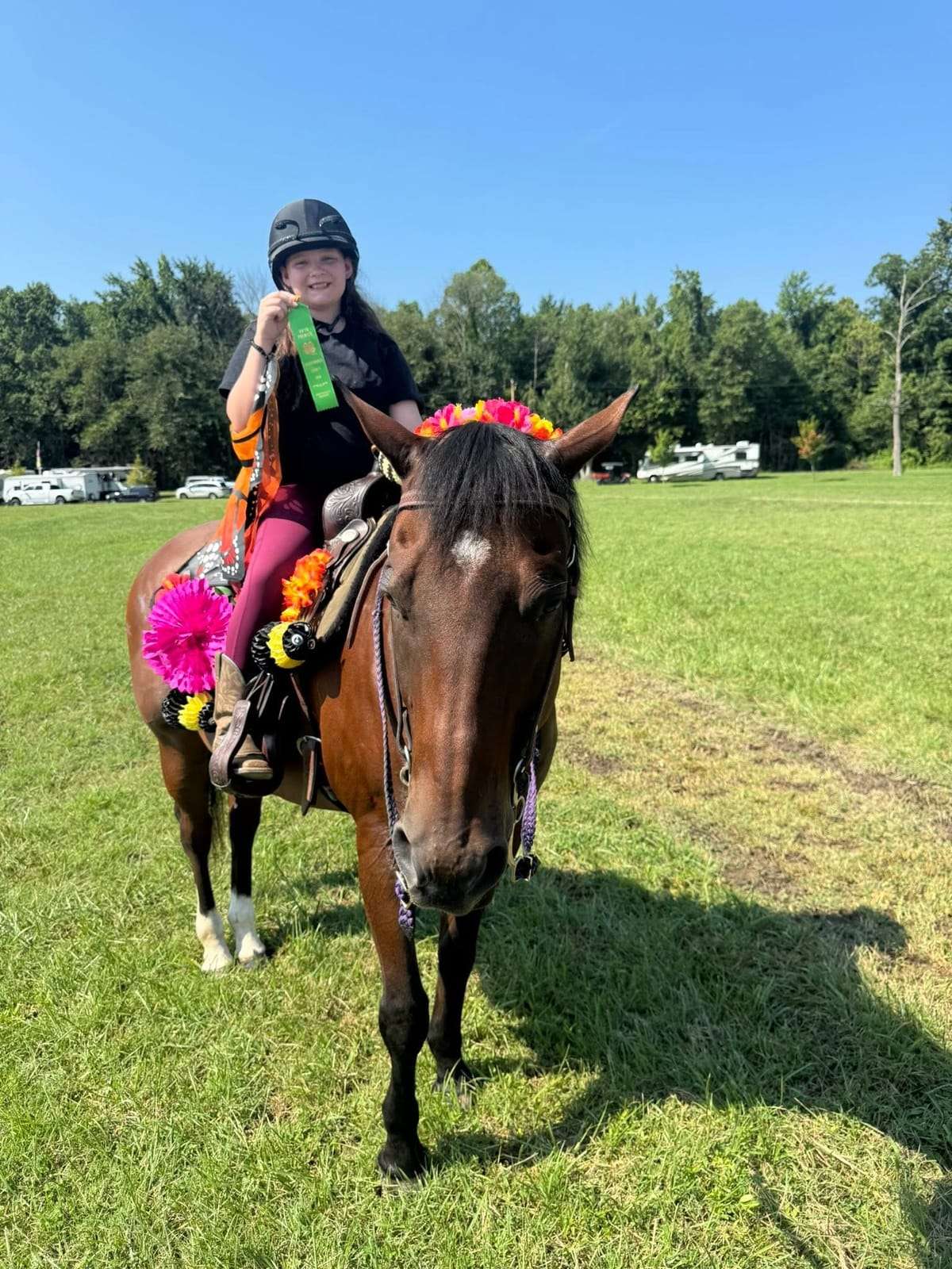 Young rider on a decorated horse at the 4-H fair
