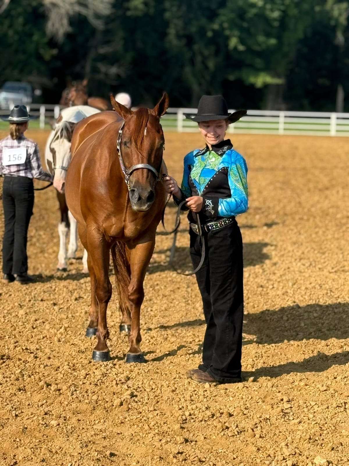 4-H rider leading her horse in the show ring