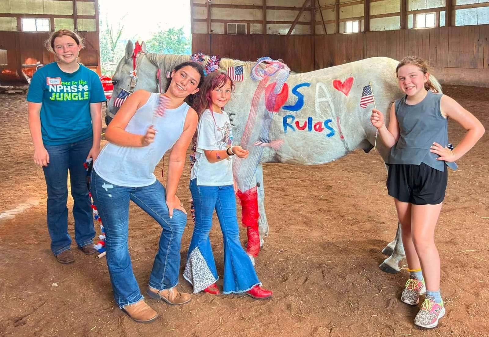 Campers posing with a patriotically painted horse