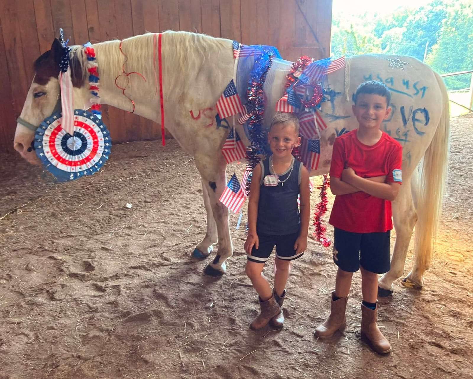 Campers with a horse decorated in red, white and blue