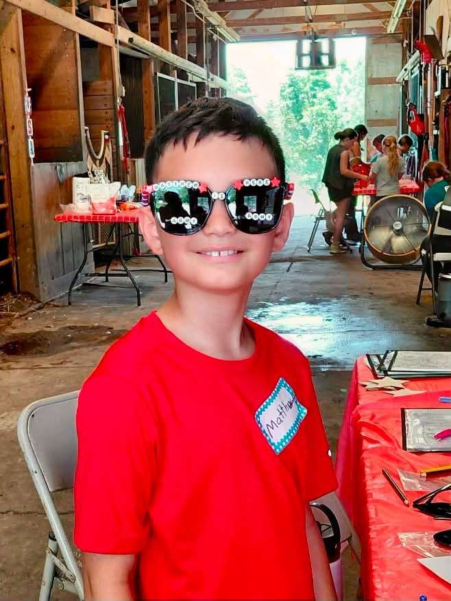 Camper wearing star-spangled sunglasses at camp