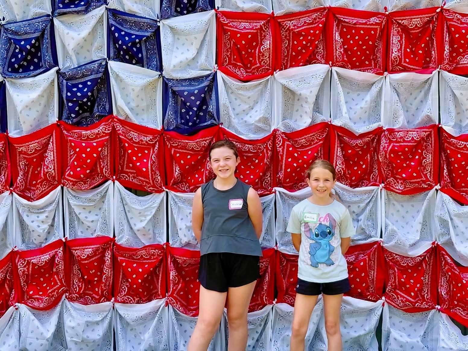Campers in front of a red-white-and-blue bandana backdrop