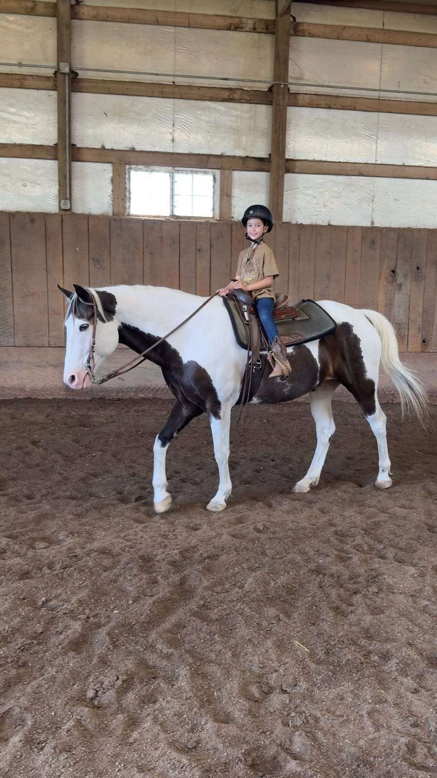 Camper riding a paint horse