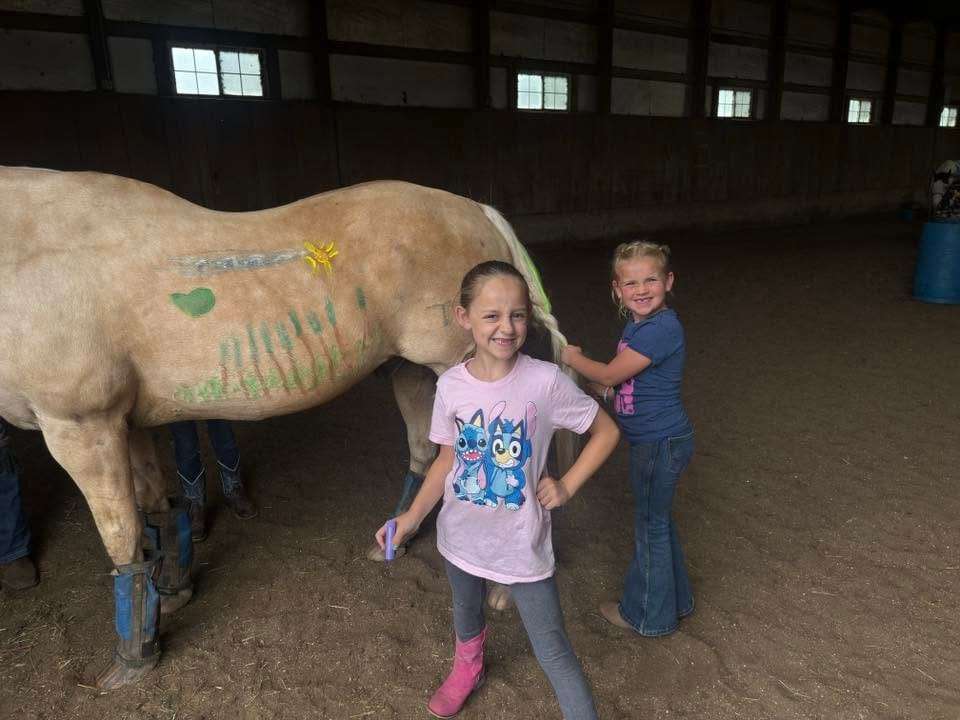 Campers with a horse they painted during the horse-painting activity