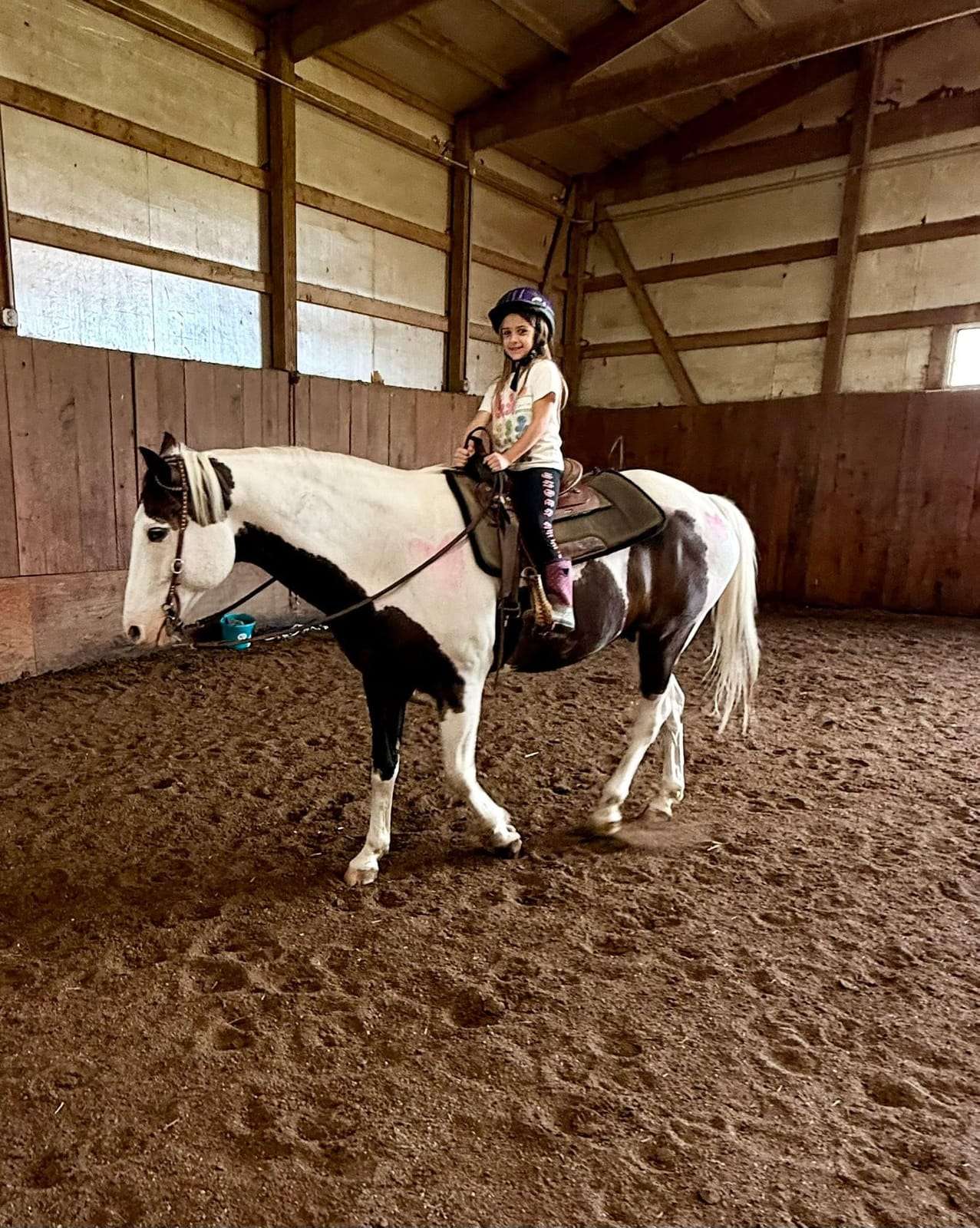 Camper riding a paint horse during 3-day camp